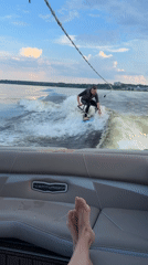 Wakesurfing session captured on Russian lake during summer afternoon