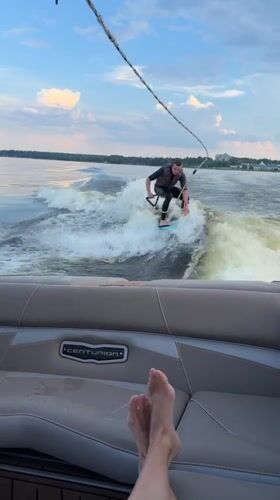 Wakesurfing session captured on Russian lake during summer afternoon