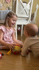 Children play with toys on wooden floor in Balashikha