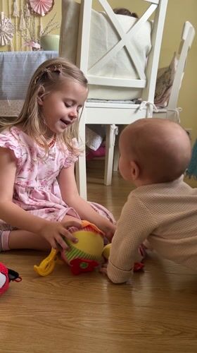 Children play with toys on wooden floor in Balashikha