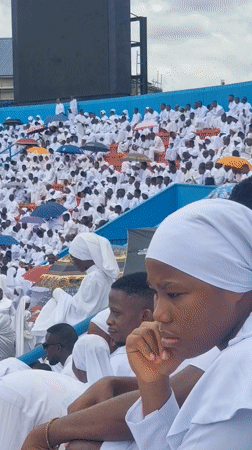 White-clad crowd gathers at outdoor stadium in Calabar