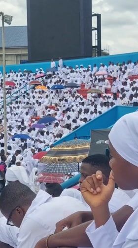 White-clad crowd gathers at outdoor stadium in Calabar