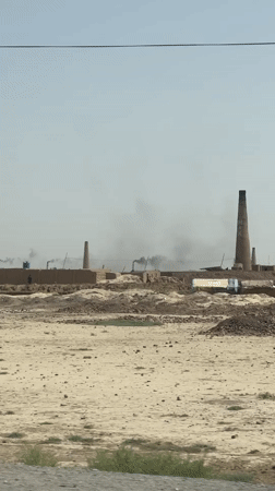 Smokestack activity at a dusty rural industrial site in Pakistan