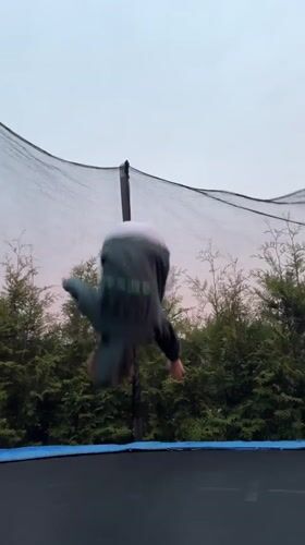 Child plays on trampoline during sunset in Carnikava, Latvia