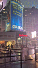 A rainy summer evening moving through Midtown Manhattan
