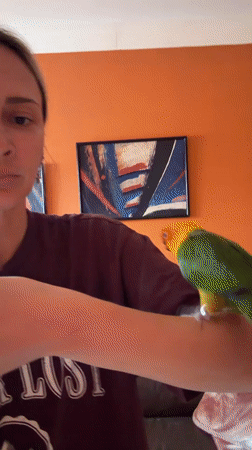 Woman poses with colorful parrot in Khimki, Russia