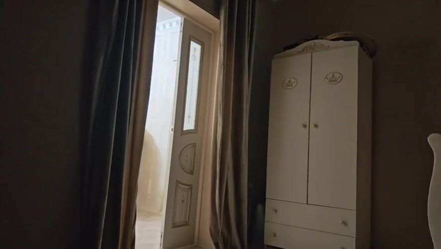 White wardrobe with gold trim inside a Mayrtup room