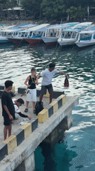 Fishing group gathers on pier in Pemenang, Indonesia