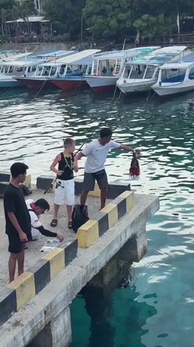 Fishing group gathers on pier in Pemenang, Indonesia