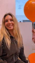Woman poses with DODO-branded balloons in Budva, Montenegro