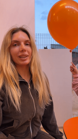 Woman poses with DODO-branded balloons in Budva, Montenegro