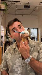 Man poses with two-scoop ice cream cone for camera