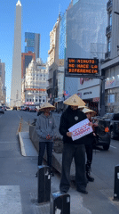 Three people in conical hats hold China sign in Buenos Aires