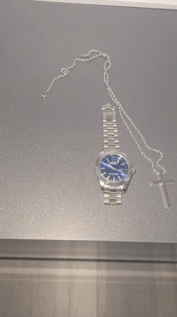 Watch and cross chain laid out for a #WristCheck post