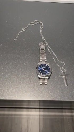 Watch and cross chain laid out for a #WristCheck post