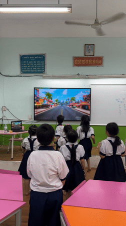 Students watch classroom television during morning session in Ho Chi Minh City