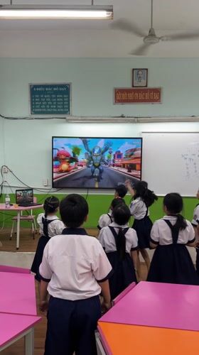 Students watch classroom television during morning session in Ho Chi Minh City