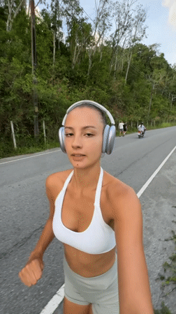 Woman jogs while filming herself in Chalong, Thailand