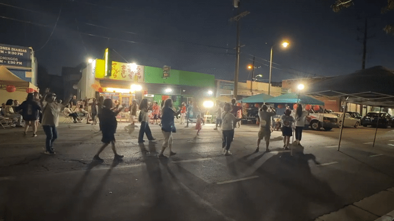 Late-night street gathering with live drumming in Los Angeles