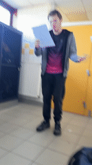 Student reads from papers in Schiltigheim school hallway