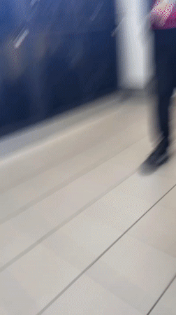 Student reads from papers in Schiltigheim school hallway