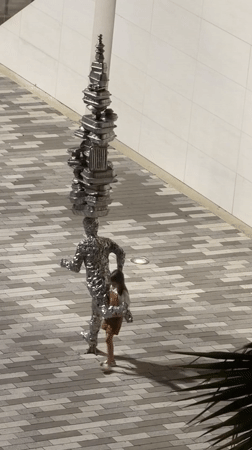 Late-night Aventura plaza: chess art, street performance, and murals