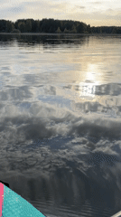 Paddleboarder films serene lake scene in Chaykovsky, Russia