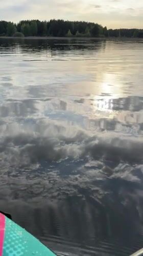Paddleboarder films serene lake scene in Chaykovsky, Russia