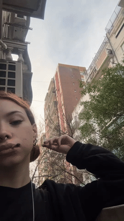 Person smoking on Buenos Aires balcony captured by witness
