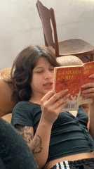Two people read on leather couch in Buenos Aires