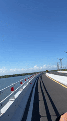 Morning motorcycle ride across bridge in South Denpasar