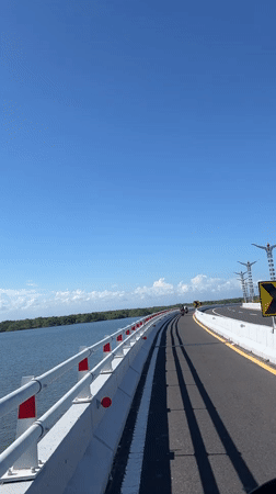 Morning motorcycle ride across bridge in South Denpasar