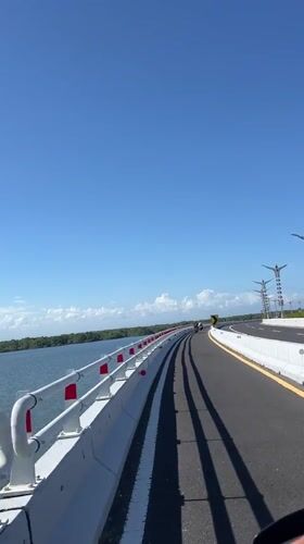 Morning motorcycle ride across bridge in South Denpasar