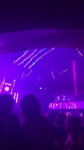 Buenos Aires nightclub crowd under pulsing purple and blue lights