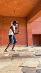 Man dances on porch in Nigeria