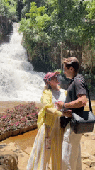 Couple poses for photo at Da Lat waterfall