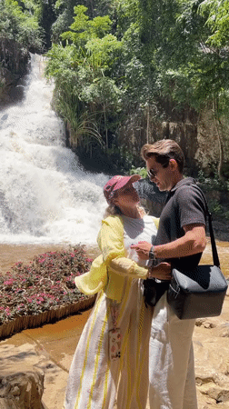 Couple poses for photo at Da Lat waterfall