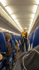 Flight attendant demonstrates safety procedures on Saint Petersburg aircraft