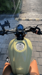 Motorcyclist pauses on yellow Yamaha in tropical North Kuta