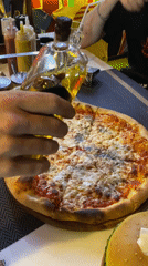 Pizza preparation captured in evening meal in Thailand