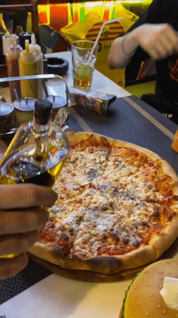 Pizza preparation captured in evening meal in Thailand