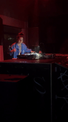 Woman DJs in red-lit room in The Hague