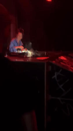 Woman DJs in red-lit room in The Hague