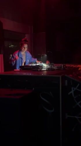 Woman DJs in red-lit room in The Hague