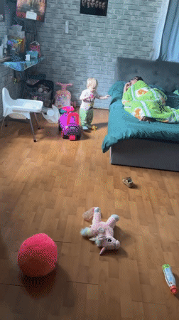 Child and person captured in domestic bedroom scene, Vesyoloye