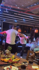 Dancing and dining captured at Klas Bistro's lit evening atmosphere