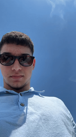 Young men enjoy sunny boat ride through Venice canals