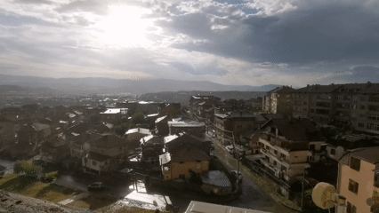 Post-rain sunlight illuminates Blagoevgrad urban landscape from elevated viewpoint