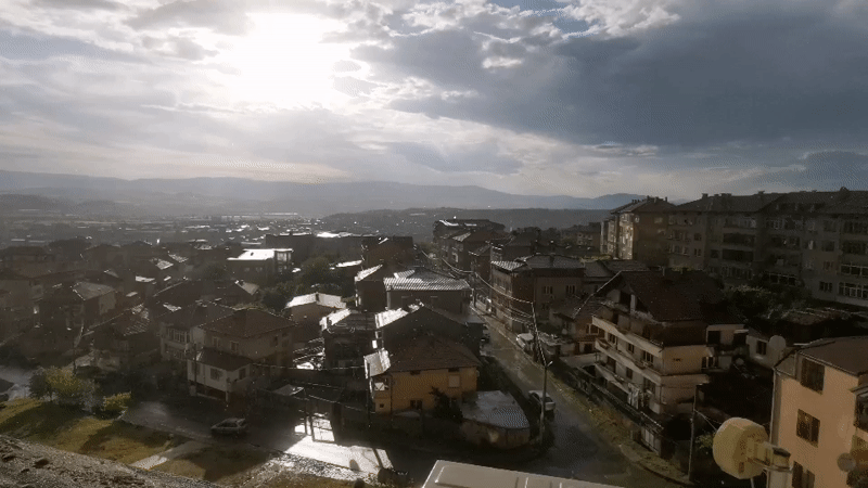 Post-rain sunlight illuminates Blagoevgrad urban landscape from elevated viewpoint
