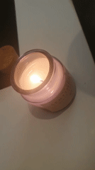 Candle burns in glass jar in Plovdiv evening